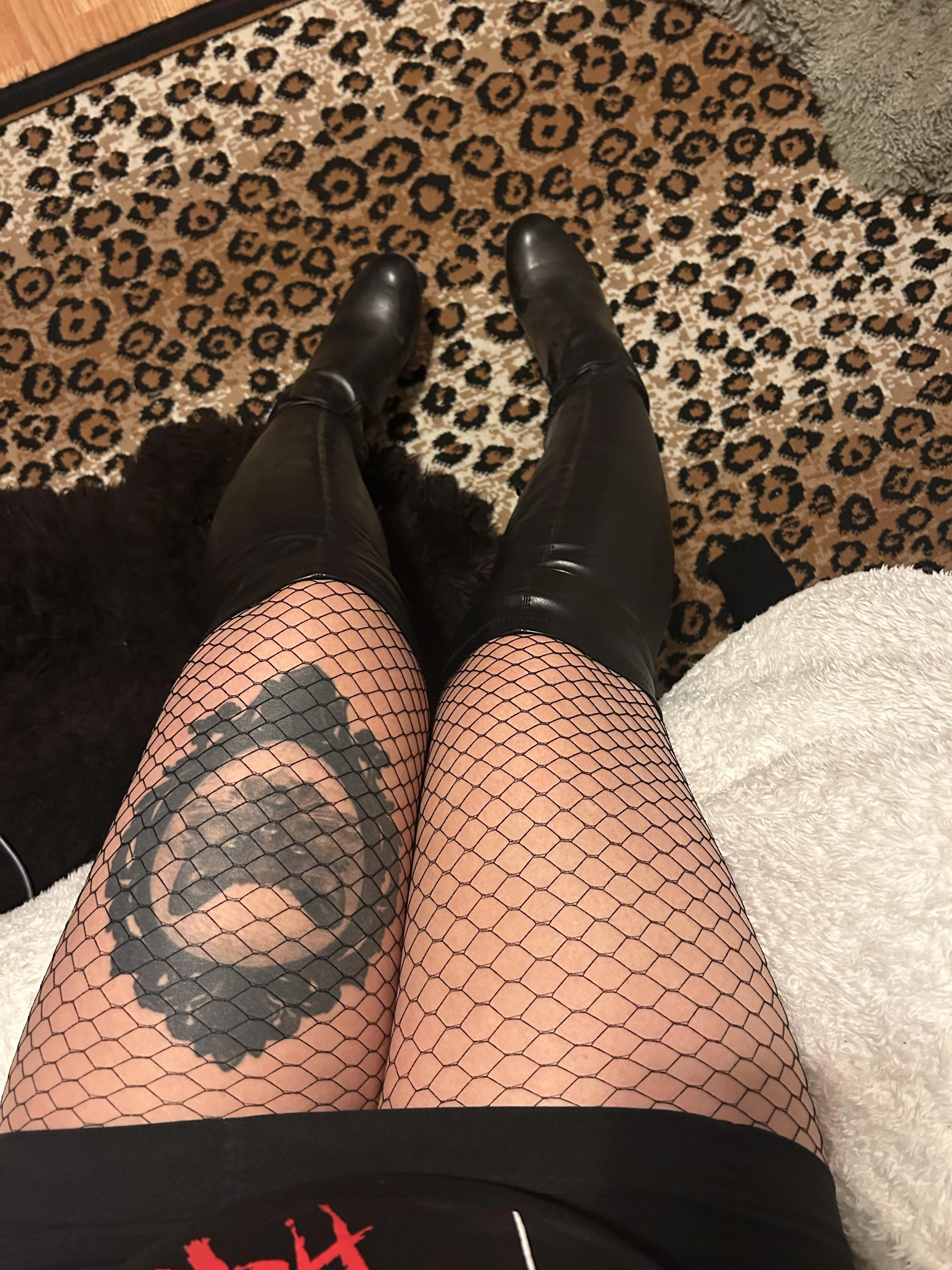 Knee high boots and fishnets on an alt girl