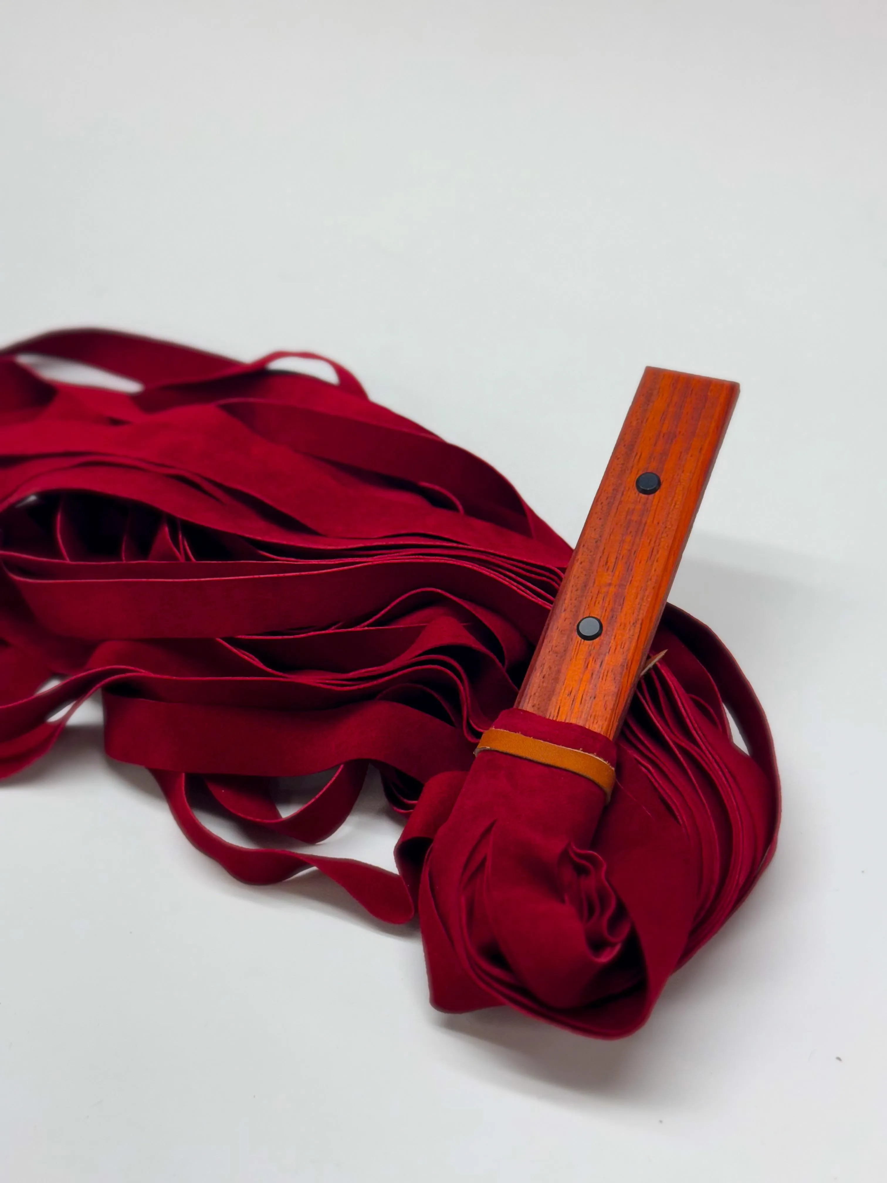 Thuddy flogger. 28 in falls made from soft and supple leather. Handle is made of Padouk.