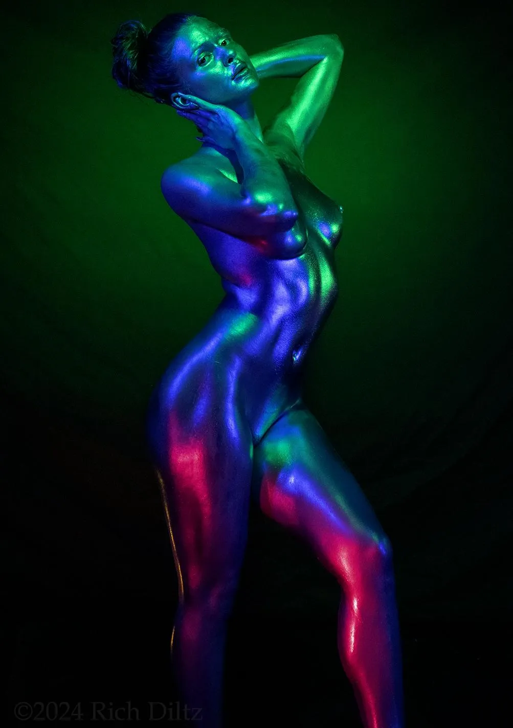 ainted Like a Lie That Tells the Truth-This isn’t armor.
It’s not a costume.
It’s skin—drenched in pigment, lit like a fever dream, and offered up without apology.