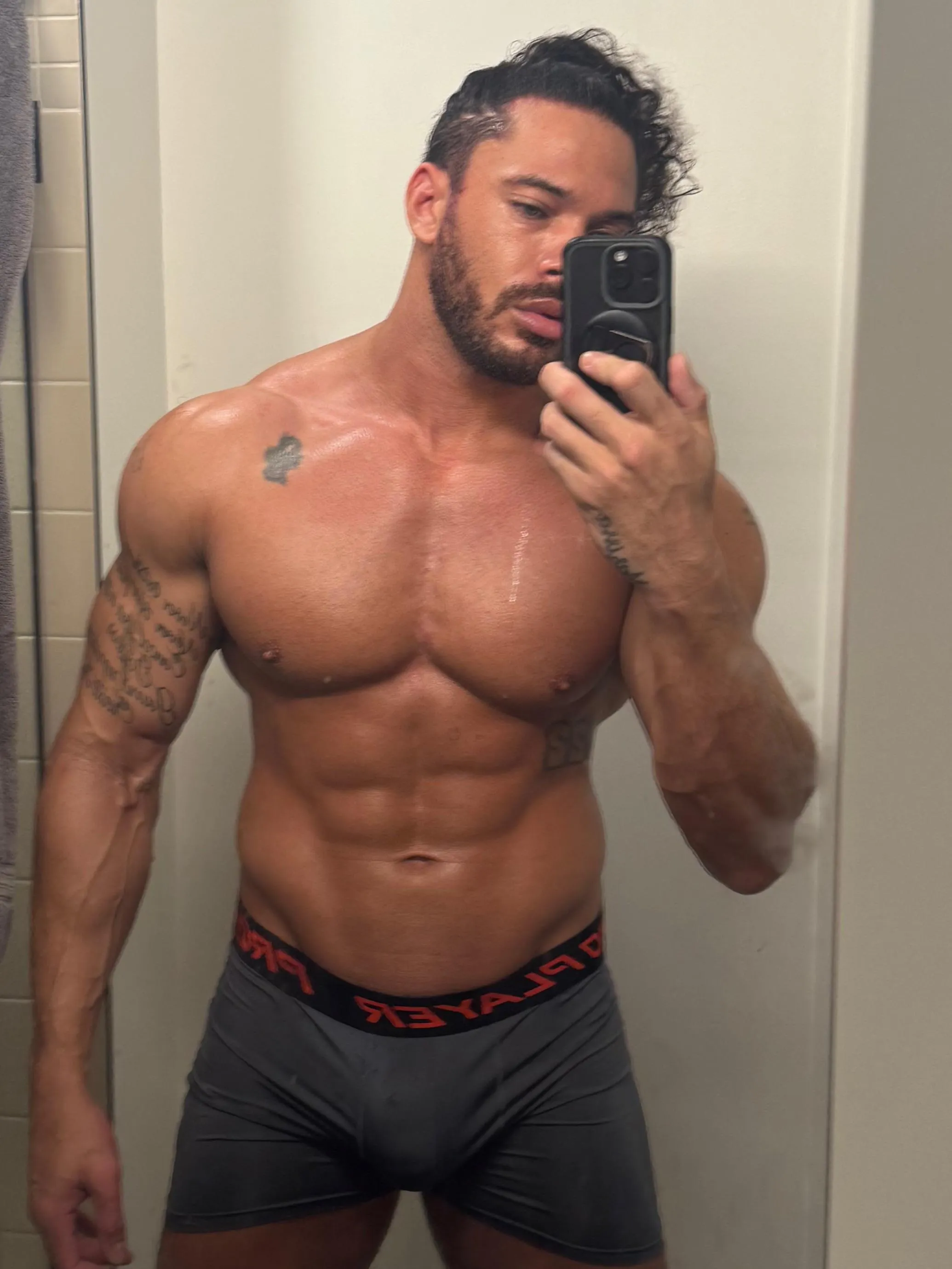 Muscles glistening fresh out of the shower