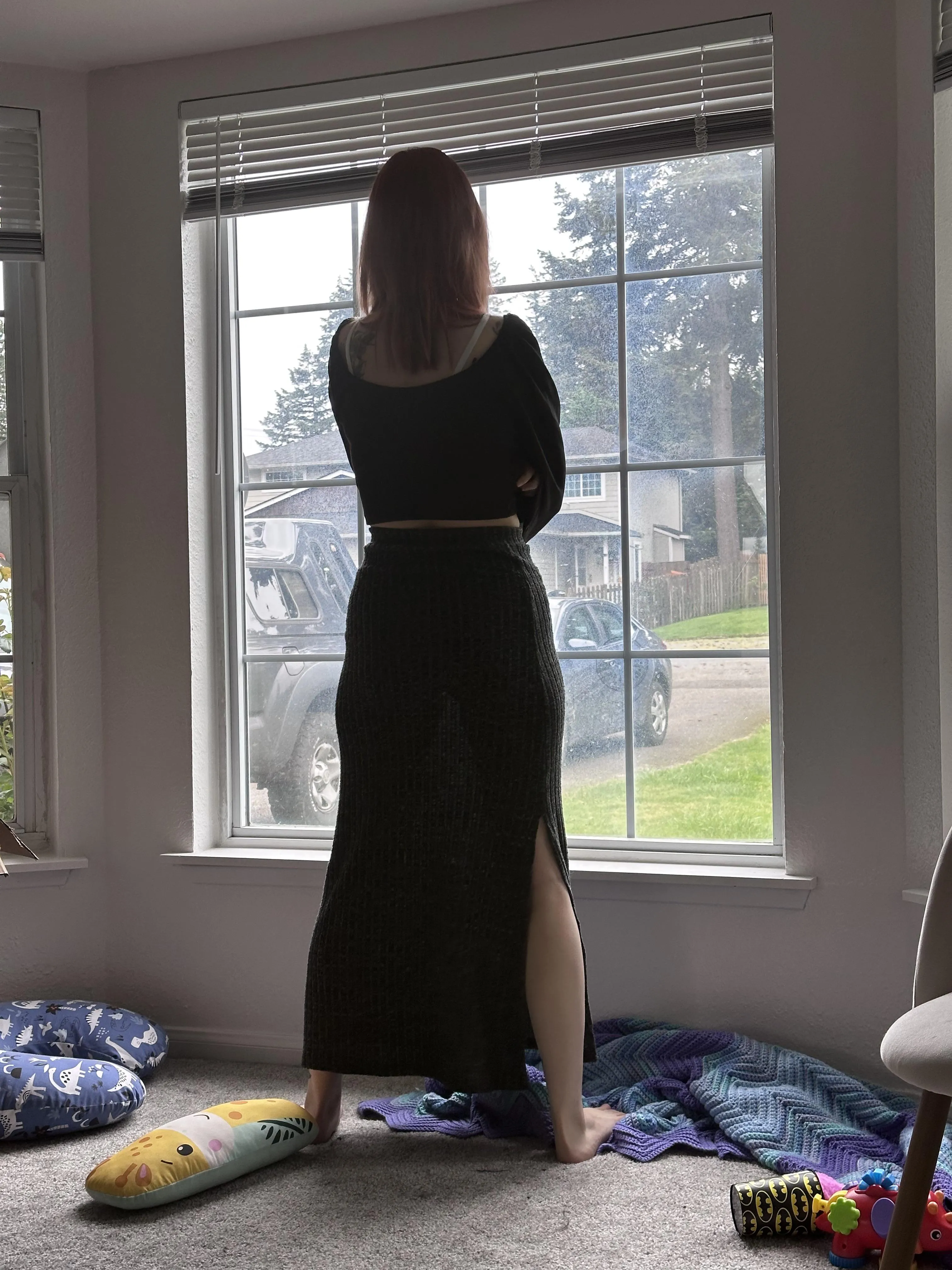 My wife standing at our window.
