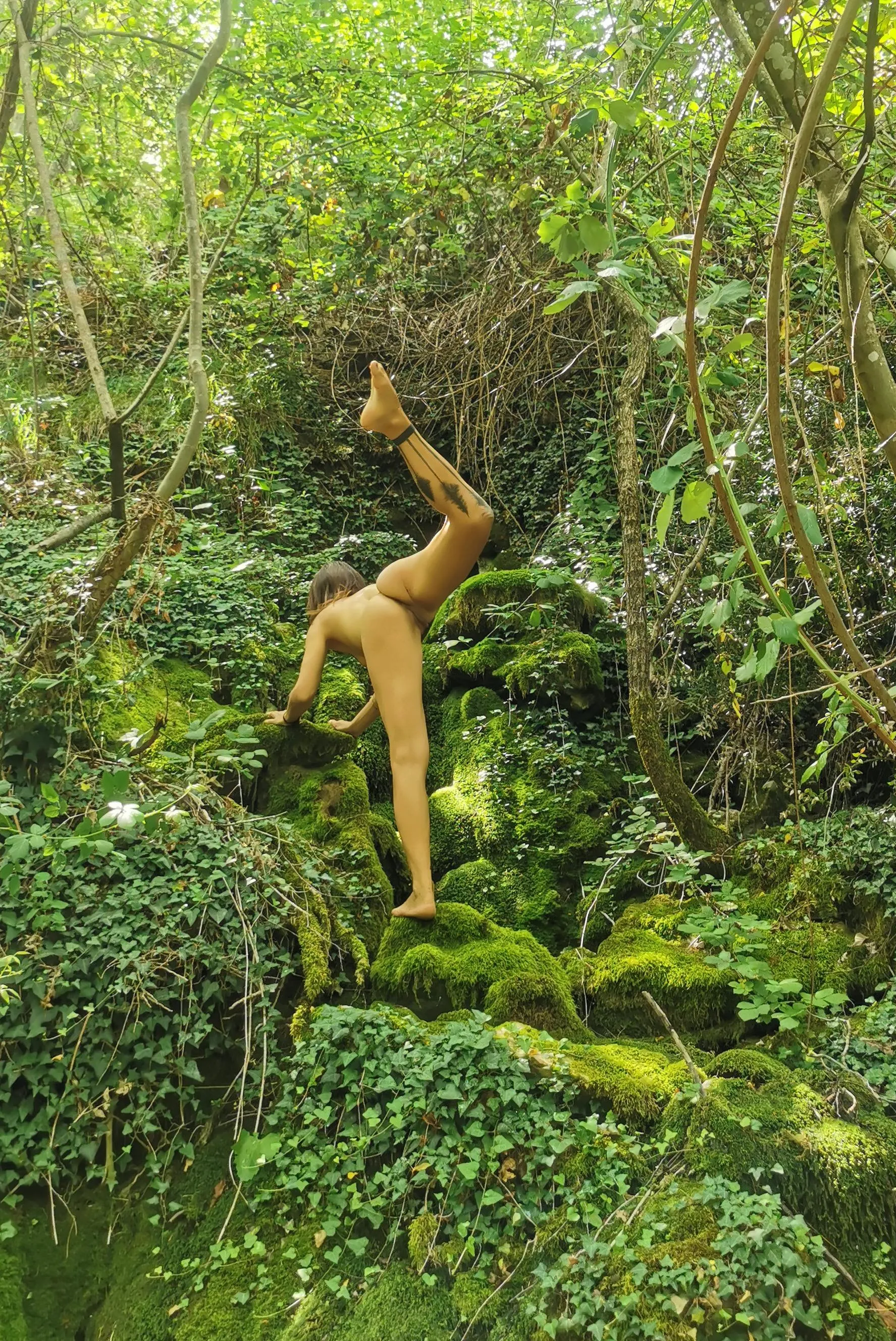 Forest yoga on a mossy rocks