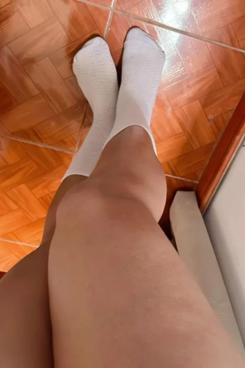 Golden latina legs. Tiny, sock covered feet. Your call, sniff or peel