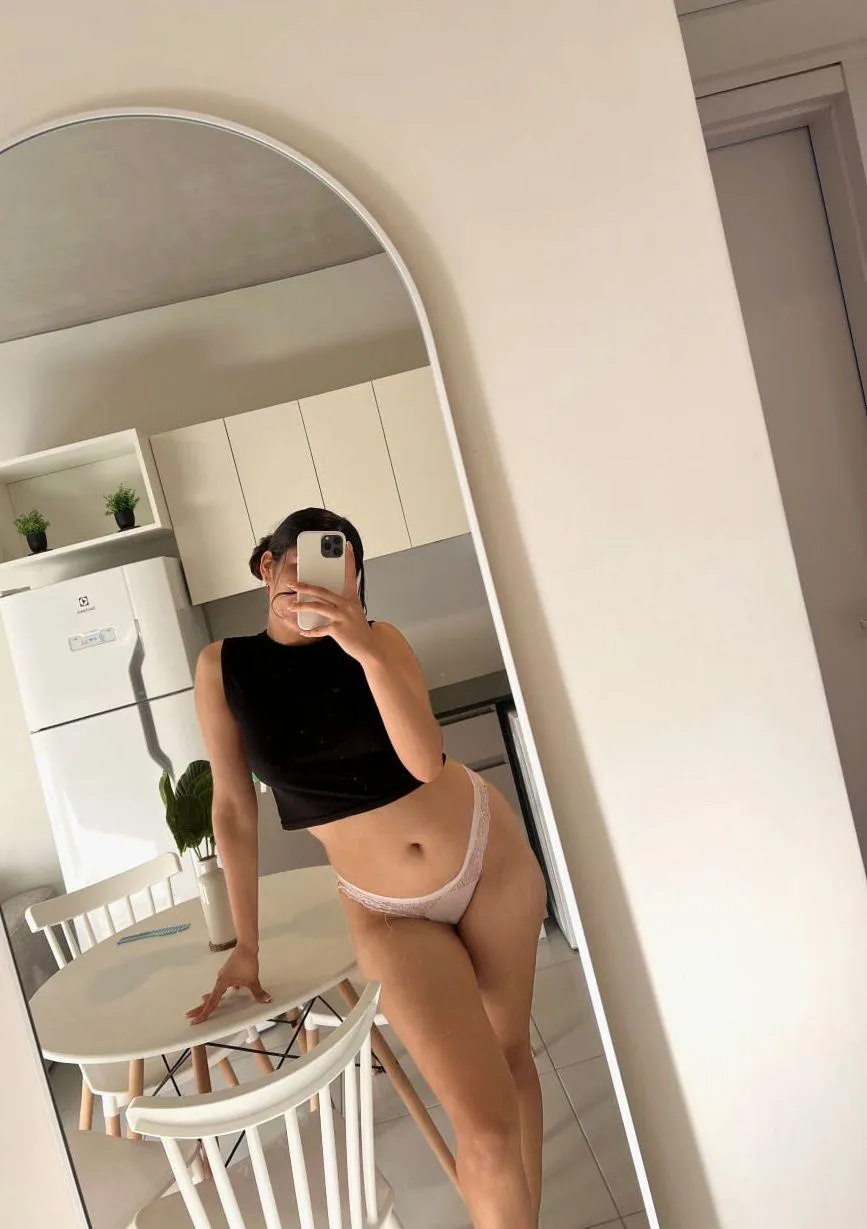 Leaning in the kitchen, legs on full display—bet you wouldn’t mind dinner like this.