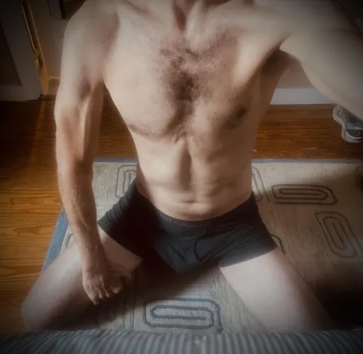 On my knees, foot of bed