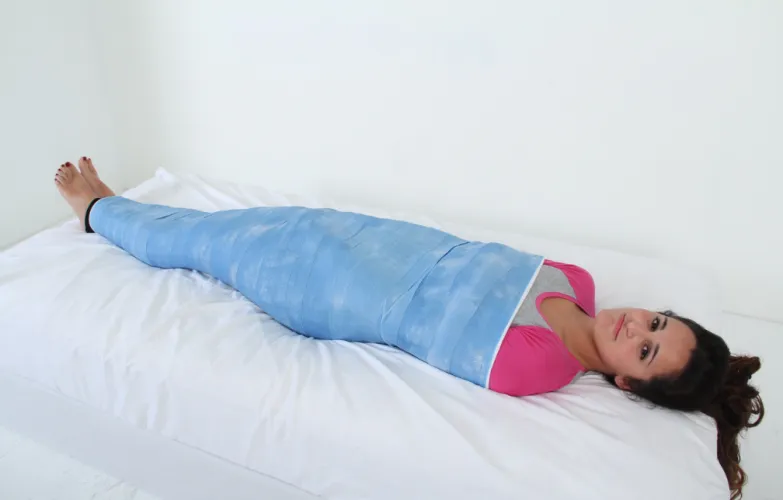 A cocoon with just enough space for Abby to serve face.