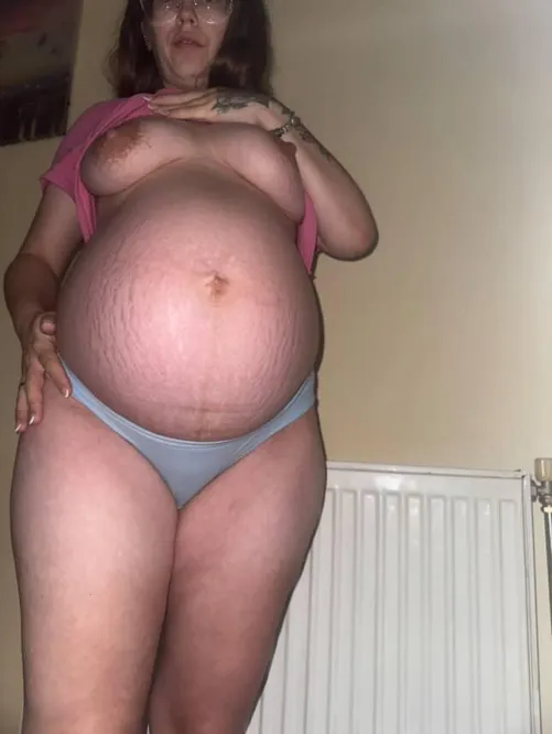 Side shot… belly stretched, tits heavy… still turning you on? 😏