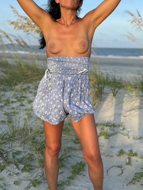 Bare breasted beach pic. 45yo wife and mom who love to show off her titties.