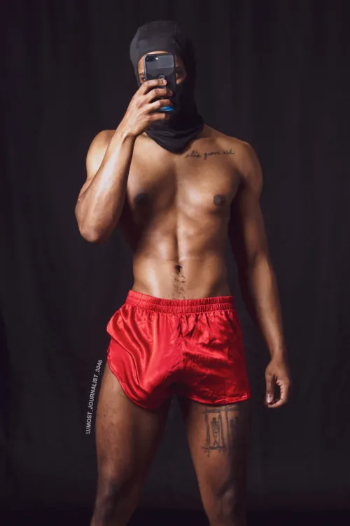Red shorts. Heavy bulge. This isn’t thirst trap — this is your new religion.