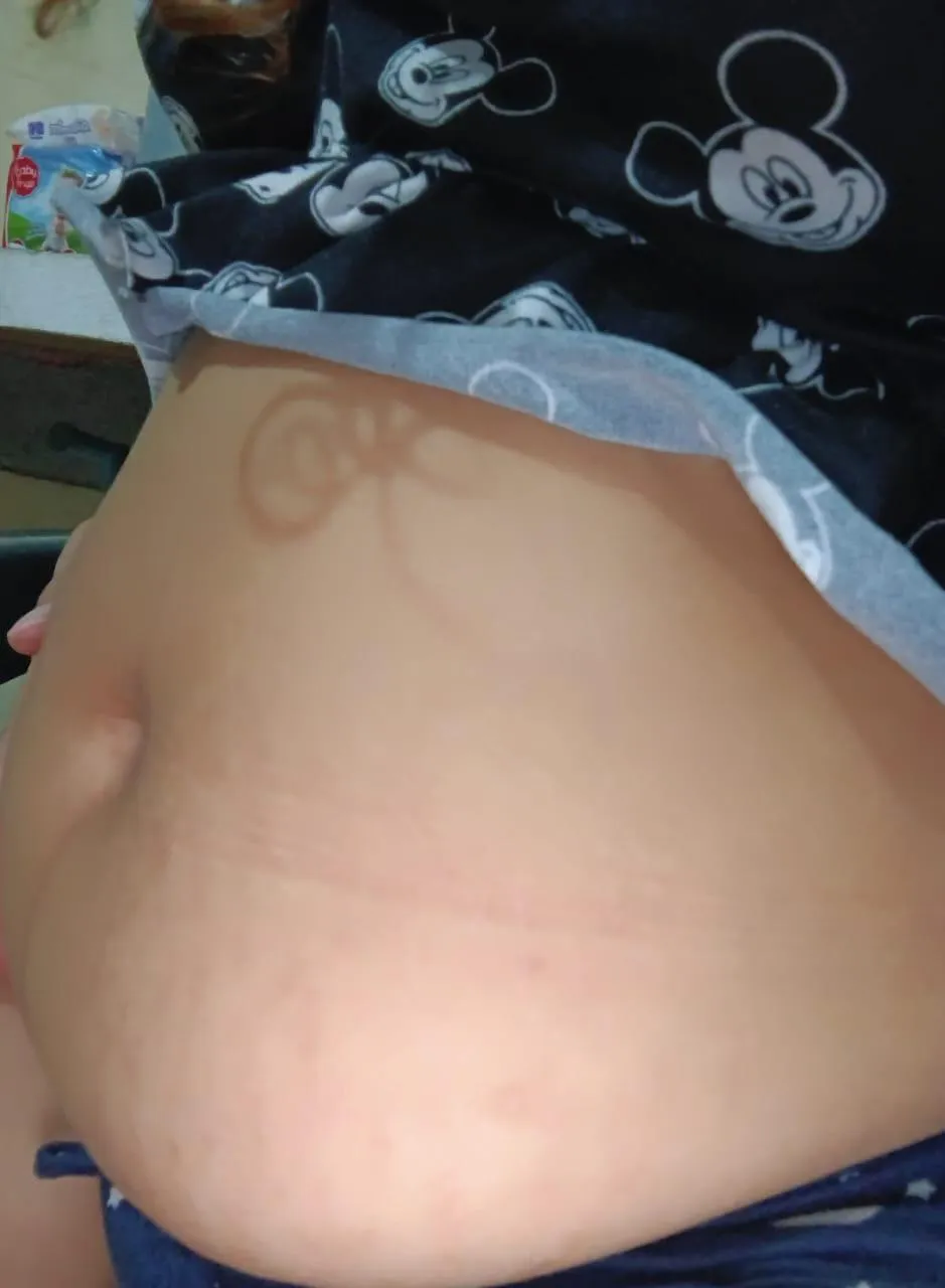 Beautiful pregnant belly, a little milk is missing on