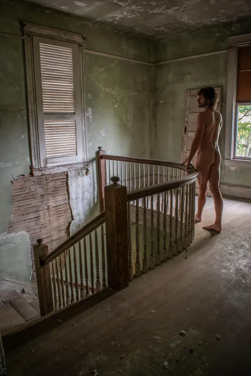 At the top of the stairs in an abandoned funeral home