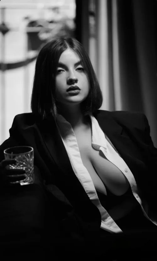 Smoldering with a cocktail and cleavage.