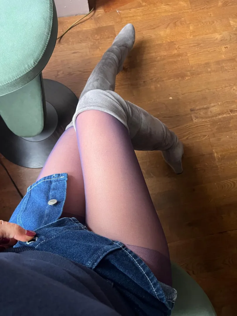 sitting elegantly at my desk in my thigh high boots