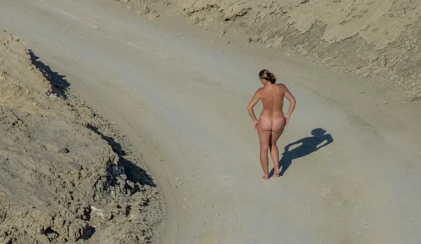 An adventurous naked stroll along the dirt road in Twenty Mule Team Canyon in Death Valley.