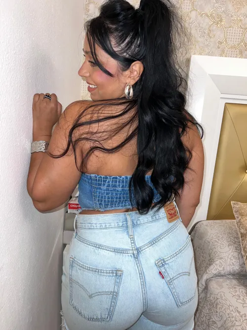 Tanned silhouette in fitted denim radiating bold heat summers sexiest seaside allure