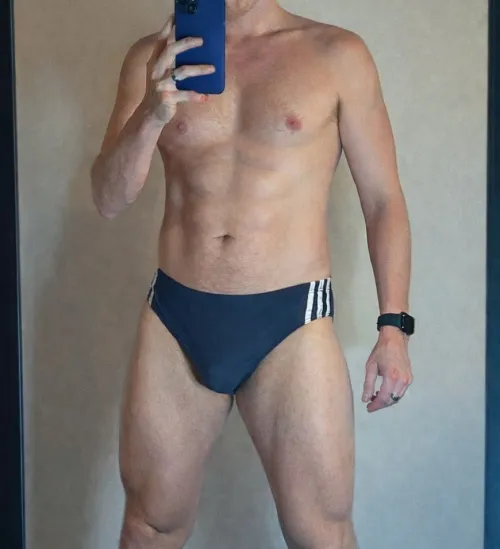 Wearing classic Adidas swim briefs