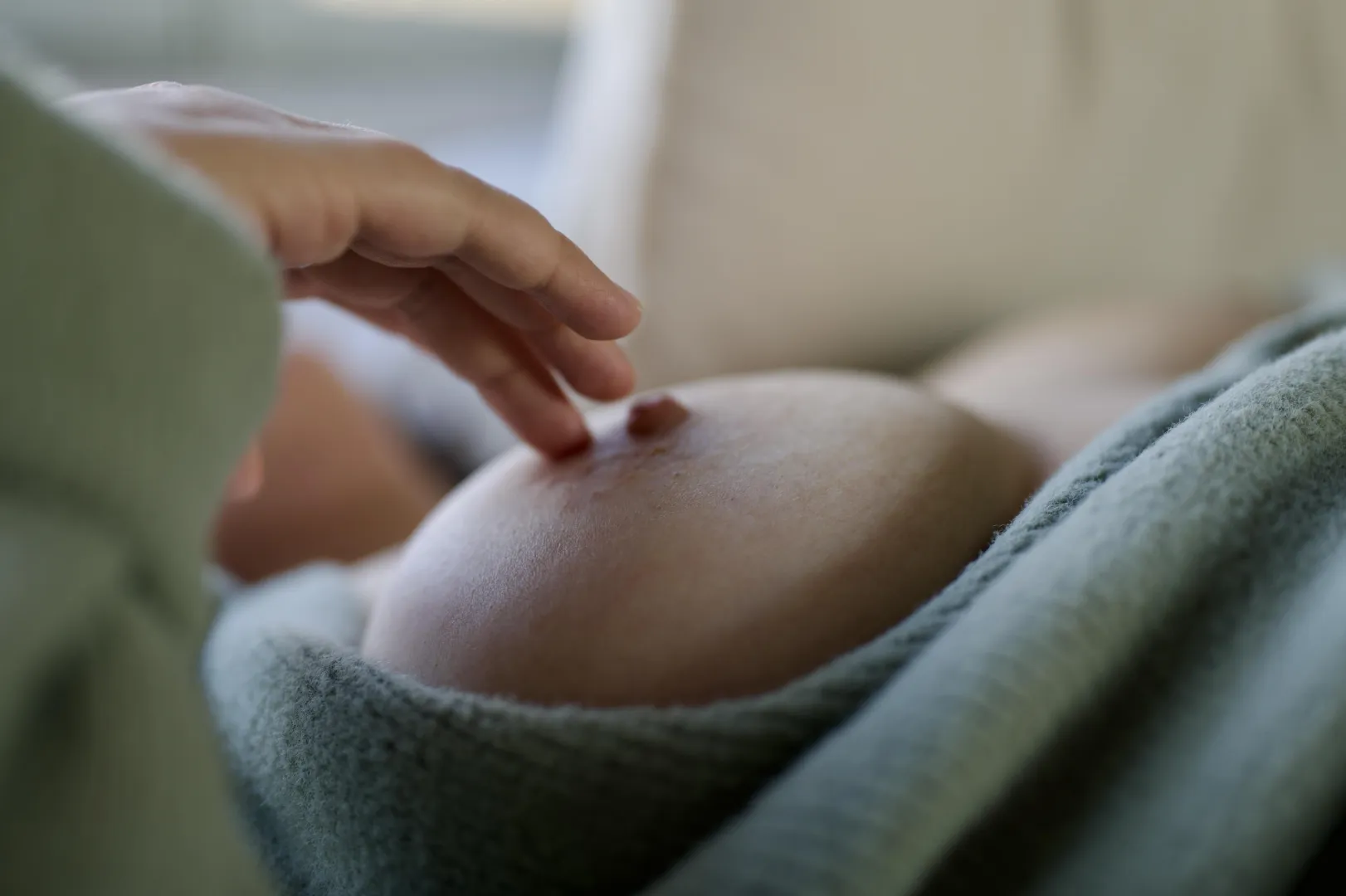 My wife lying back in her green sweater, teasing her hard nipple just for us… 