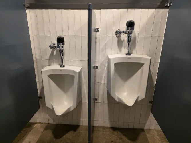 This partition between the two urinals was far too large.