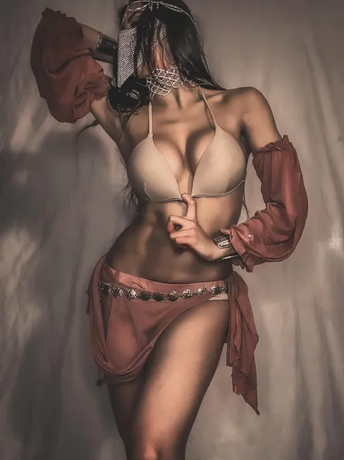 Draped in silk and mystery, she looks like a dream from a private harem fantasy