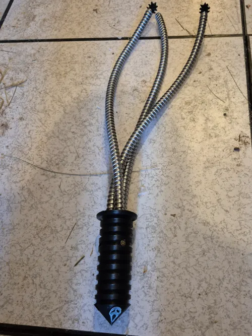 Conduit whip with 3d printed spike ends and handle.