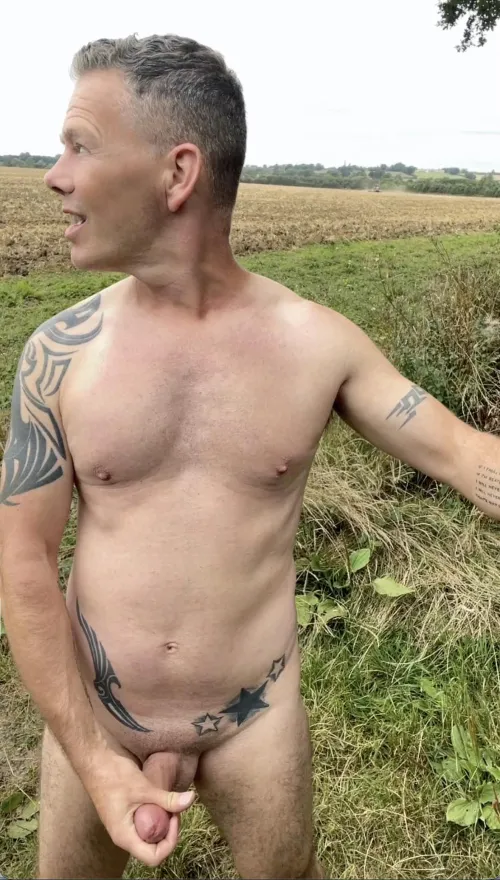 Wanking naked while the farmer watches.