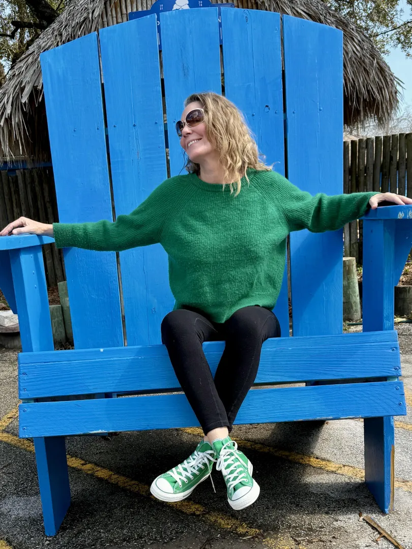 Wearing green chucks in a giant chair. 59yo