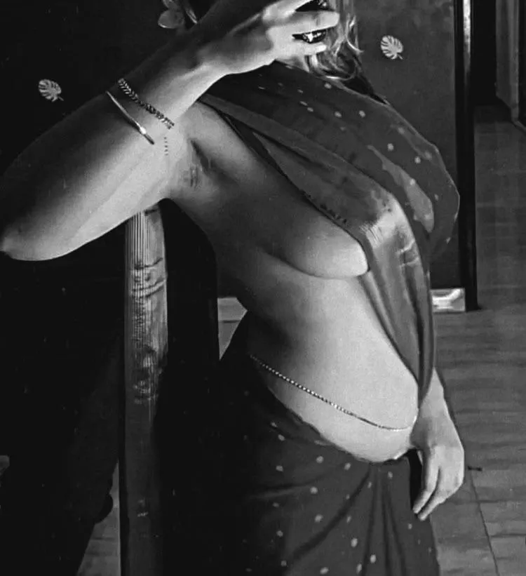 wife’s mirror tease: saree low, heavy tits, pits bush hint. Love the rush of strangers seeing what I get every night 