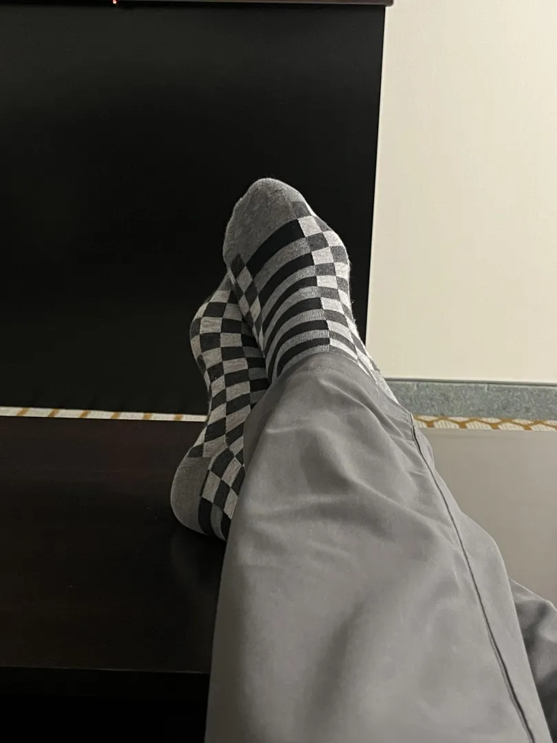 Dad (47) relaxing in the hotel after a very long work week. Who is going to take off those socks and rub Dad‘s feet?