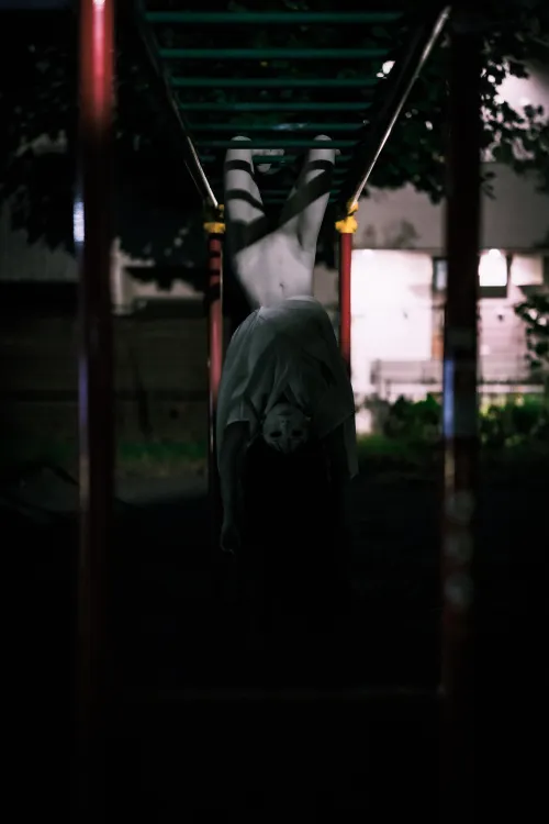 A girl on the monkey bars.