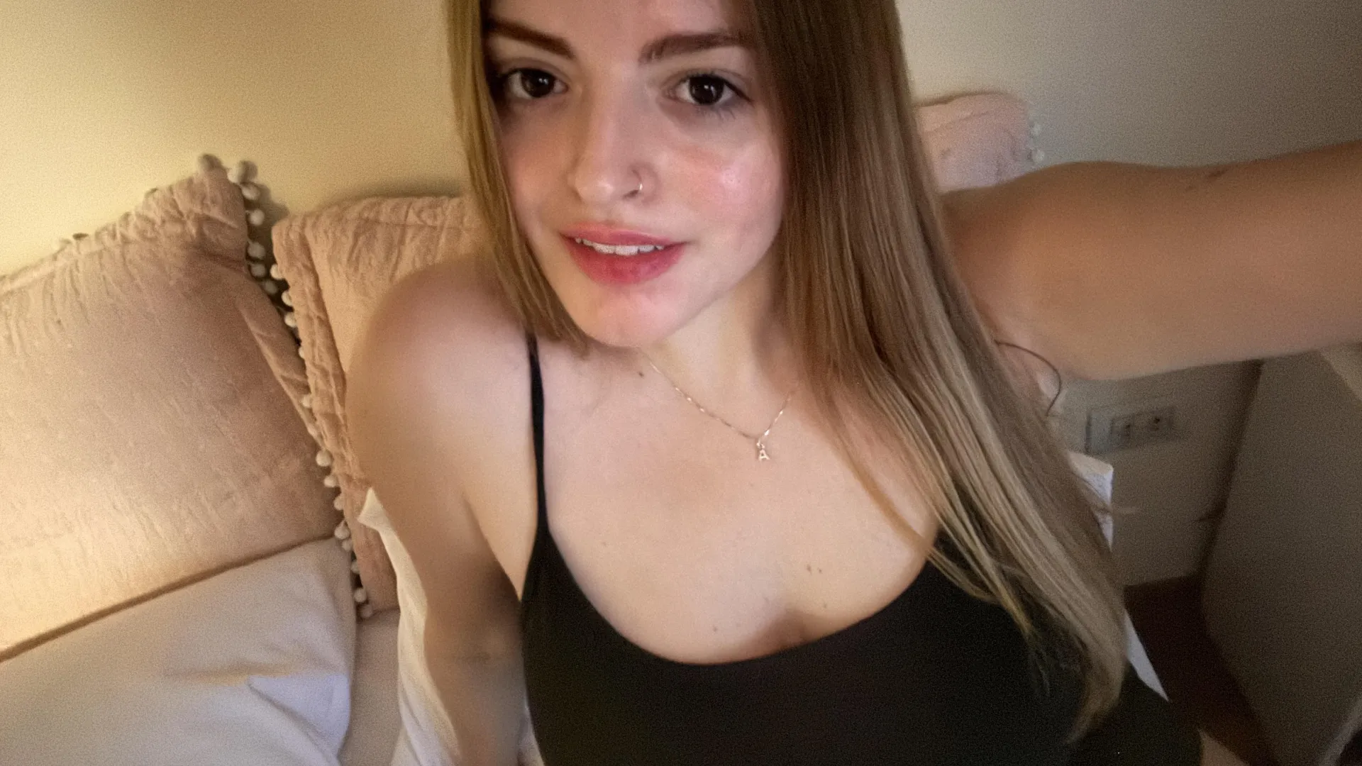 Underneath this tank top are some beautiful breasts