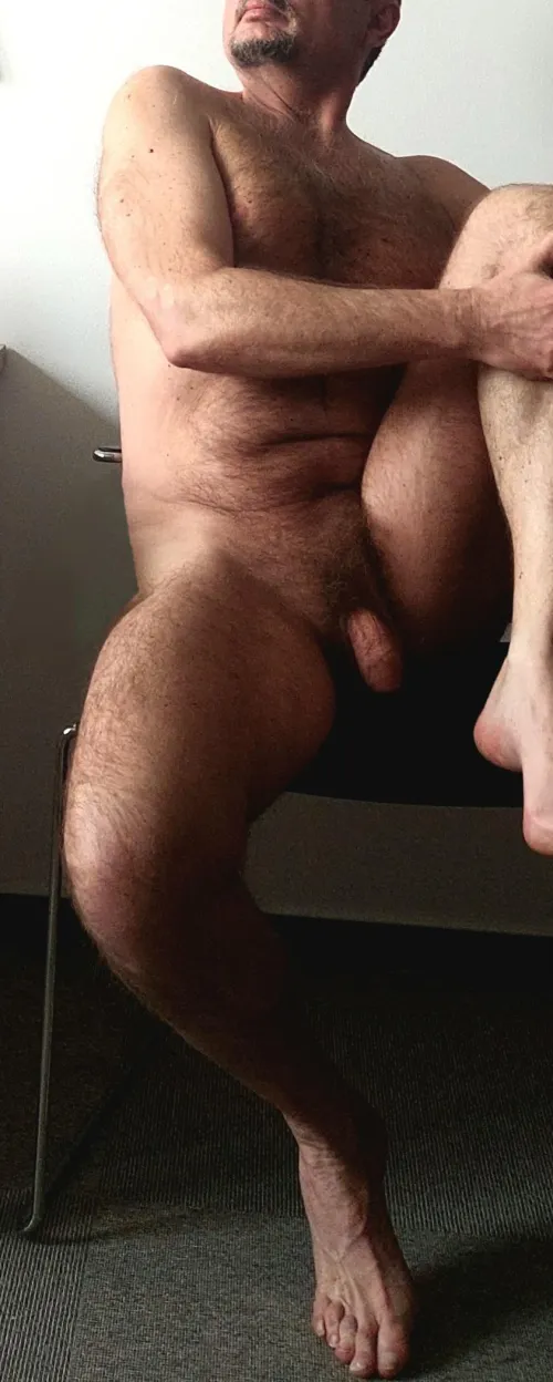 Sitting in a somewhat melancholic pose