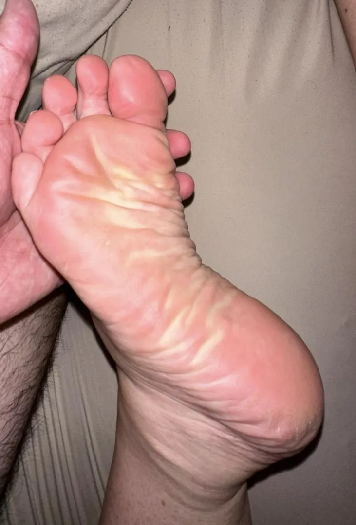Tell me what you’re doing to my wife’s foot as I hold it up for you
