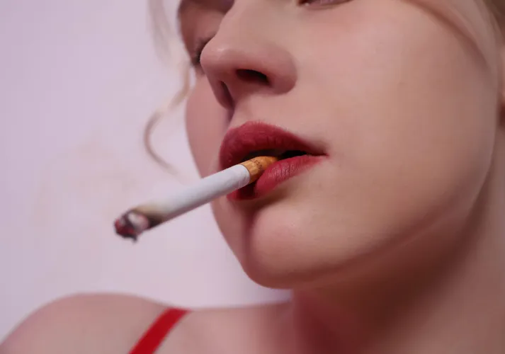 The smoke drifts into my lungs, making me happy