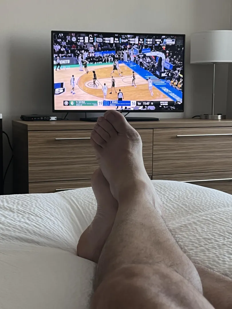 Dad (47) relaxing in my hotel room before my conference starts, and enjoying the start to the NCAA tourney. Would be extra nice if someone was rubbing my feet right now.