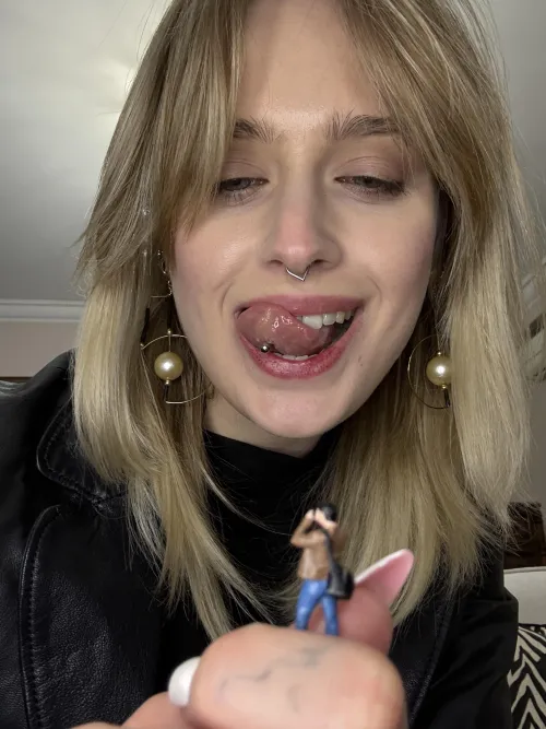 {f}he takes a photo that will be posted online with the caption 