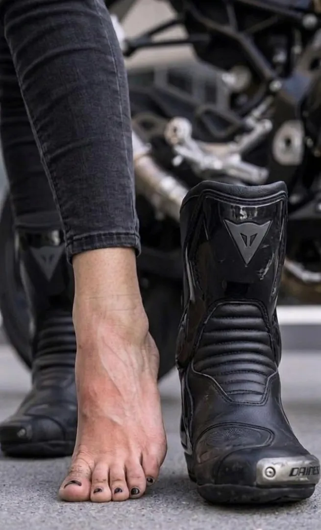 Biker girl toes marinated barefoot in biker boots