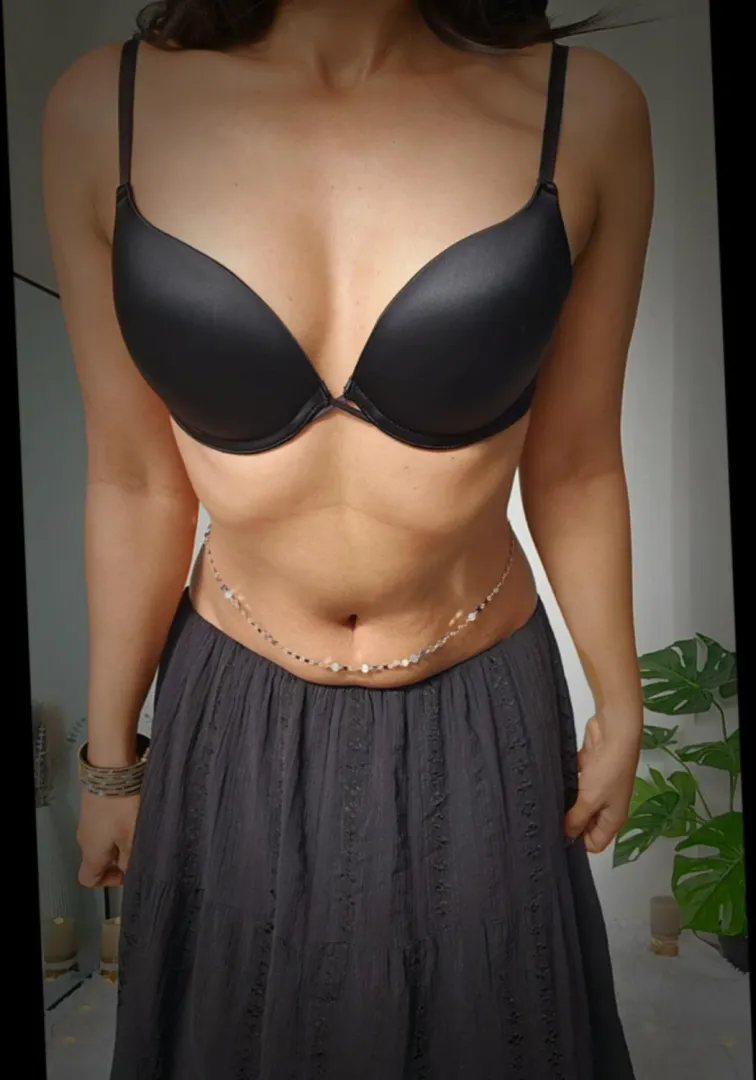 silver chain resting on my bare midriff.