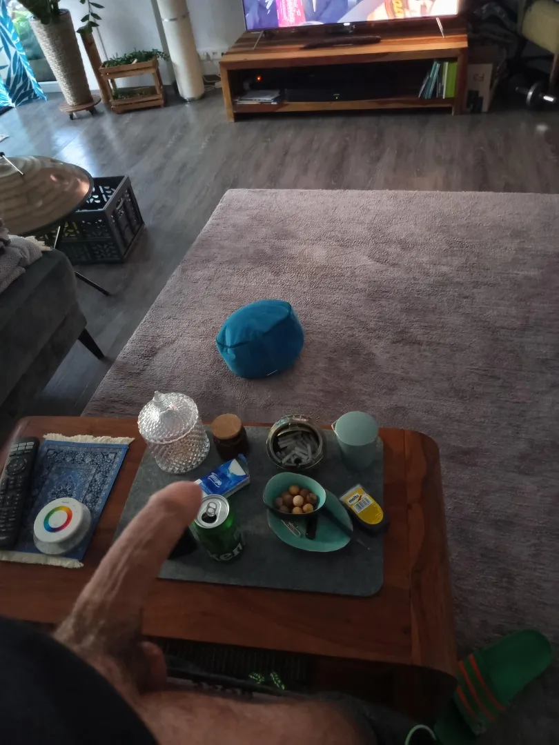 At home with TV, beer, smoke and a big cock ready to receive anyone on their knees.