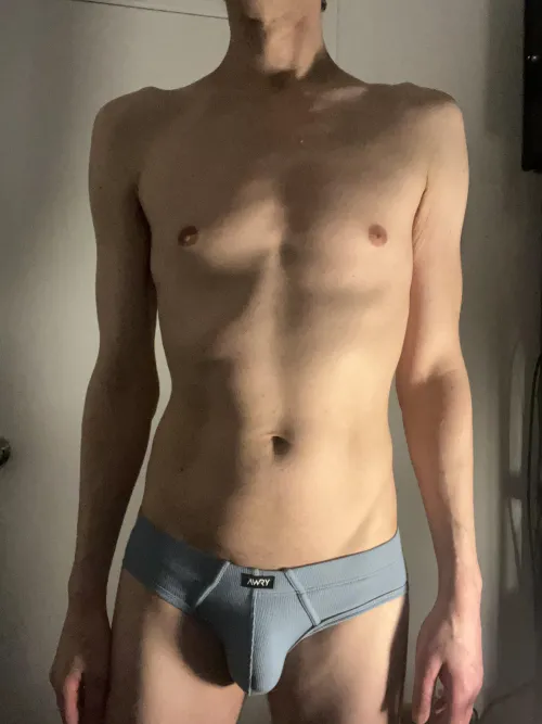 Skinny guy in light blue briefs